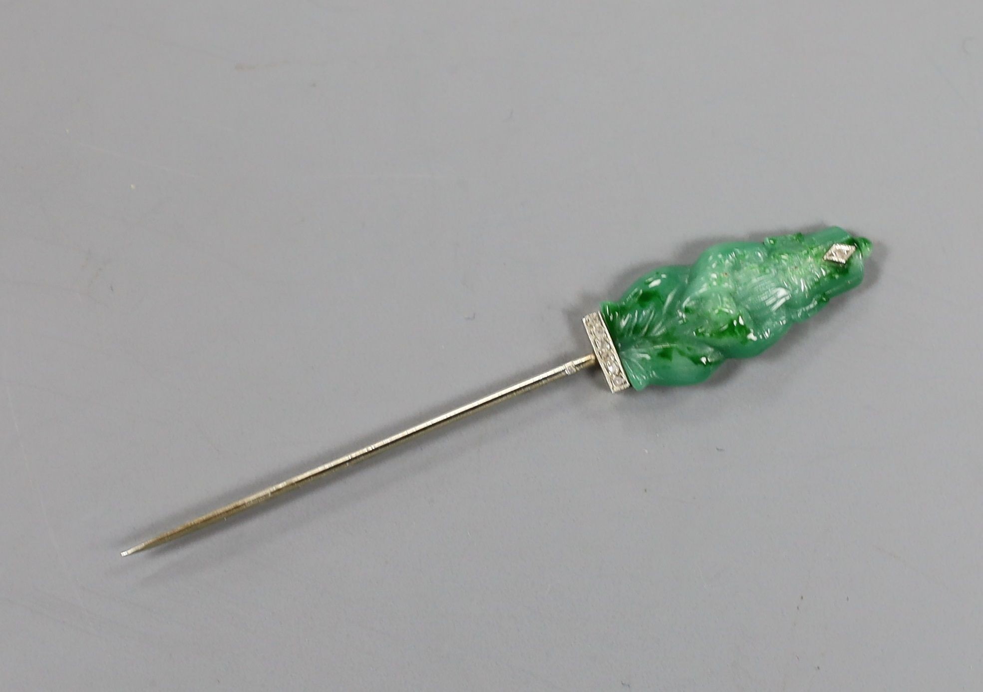 An early 20th century French white metal (18ct poincon mark), simulated jade and diamond chip set stick pin (ex jabot pin)